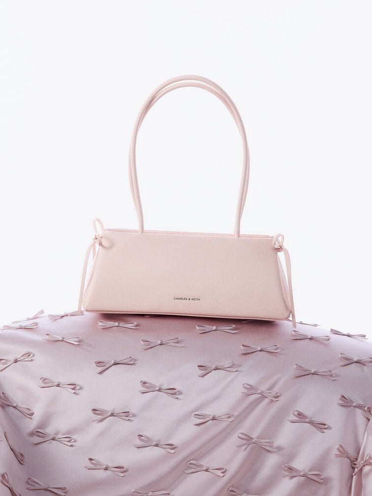 กระเป๋าสะพายไหล่ทรงสี่เหลี่ยมคางหมูแบบยาวตกแต่งด้วยโบว์รุ่น Hazel, สีซอฟต์พิงค์, hi-res