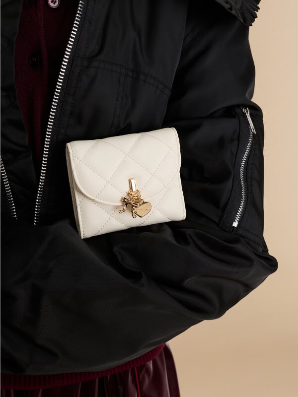 Women’s cream Arrietty quilted bow-heart charm curved-flap wallet - CHARLES & KEITH