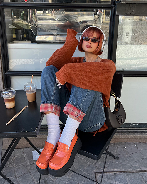 Women’s ITZY Gabine Belted Hobo Bag in dark moss; ITZY Rainier Chunky Platform Penny Loafers in orange, as seen on Ines Silva - CHARLES & KEITH