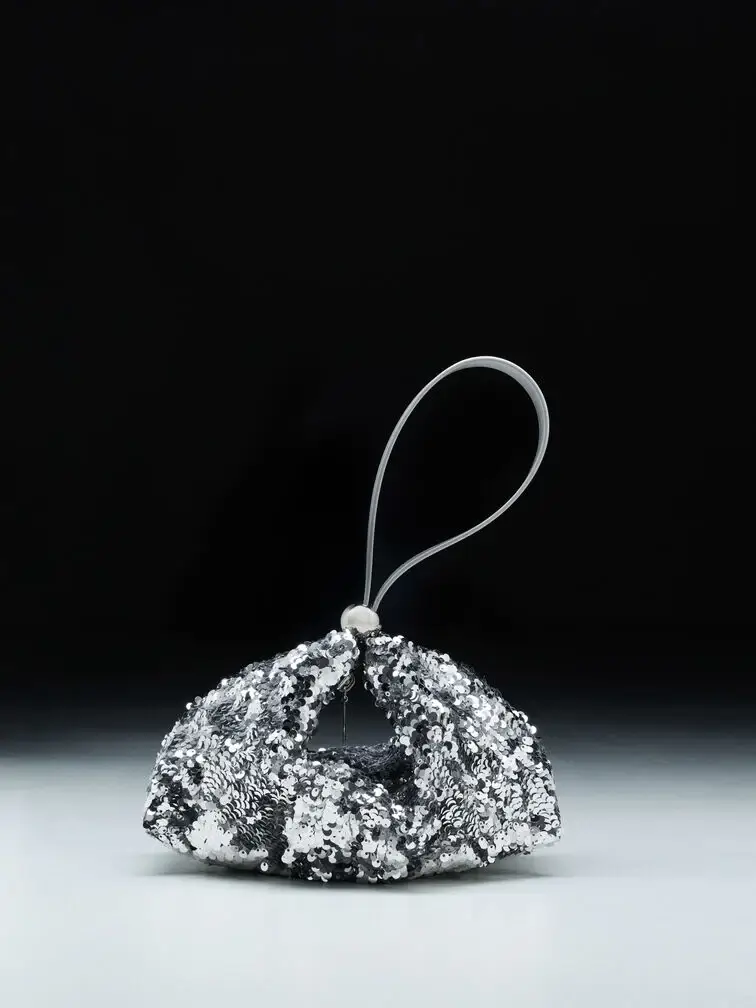 A shiny, embellished shoulder bag will suit an upscale evening wedding.