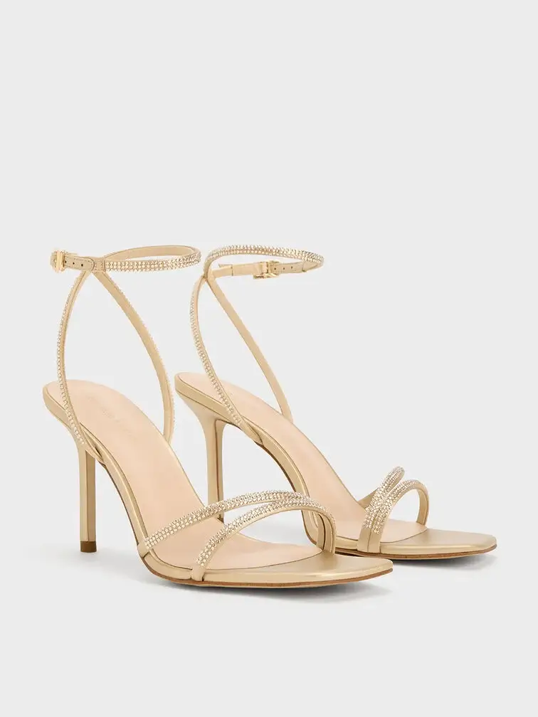 Gold stiletto-heel sandals are a glamorous option for a cocktail dress.