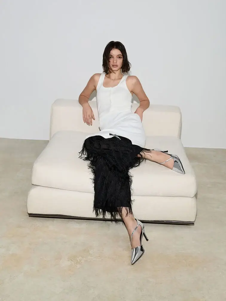 Metallic silver d’Orsay stiletto pumps, the perfect finishing touch to a dressy white tank top and feather skirt ensemble.