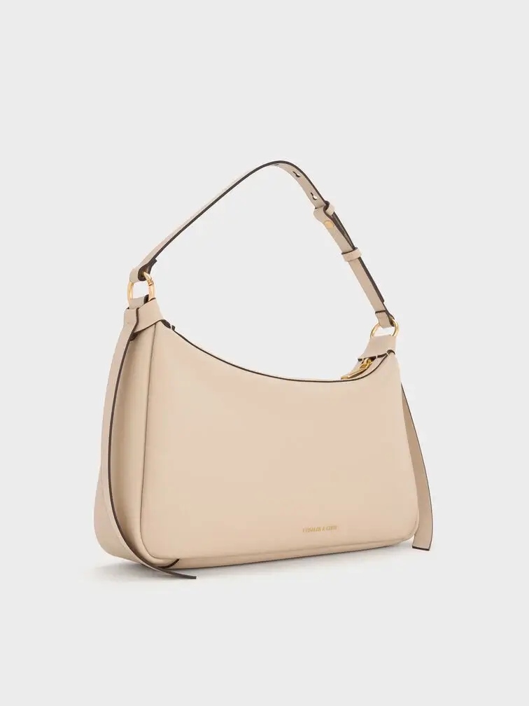 The shoulder bag is very similar to an East-West bag but with a shorter strap.