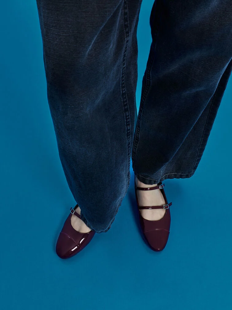 Maroon patent Mary Janes with skinny straps.