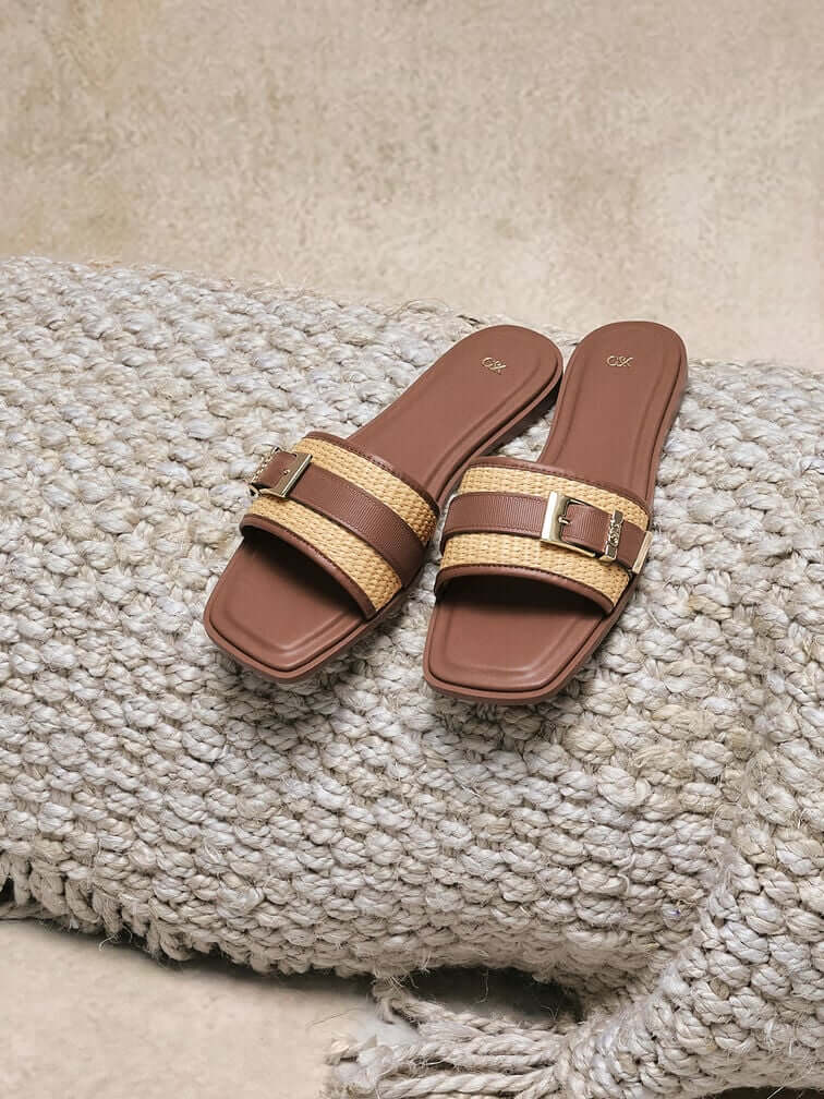 Brown leather & raffia buckled slide sandals, an essential for tropical city living.