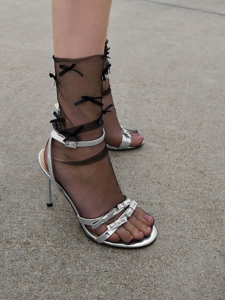 Silver sandals with bow details are an on-trend option.