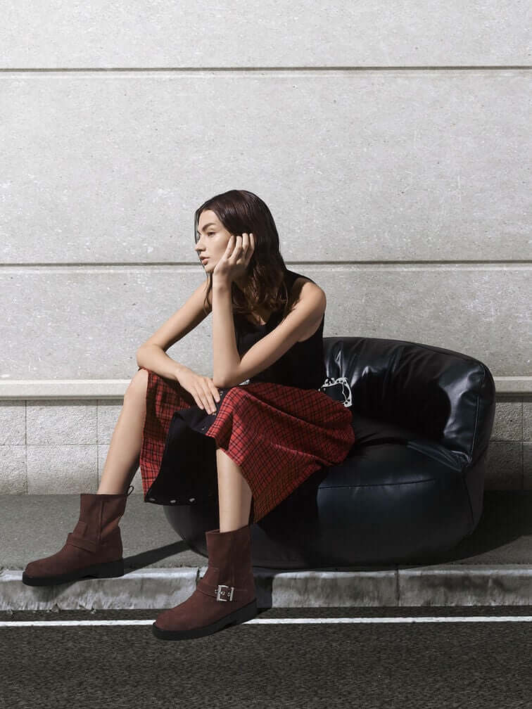 Brown biker boots styled with a red dress.