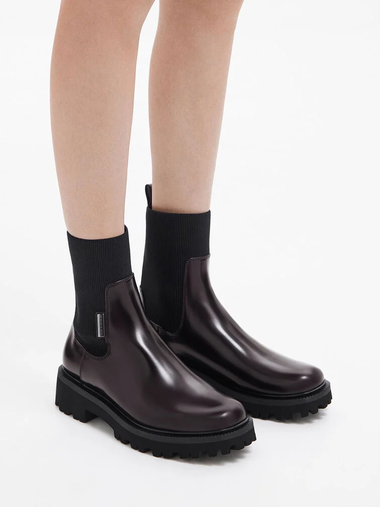 Burgundy ankle boots with fitted sock shafts pair surprisingly well with barrel jeans.