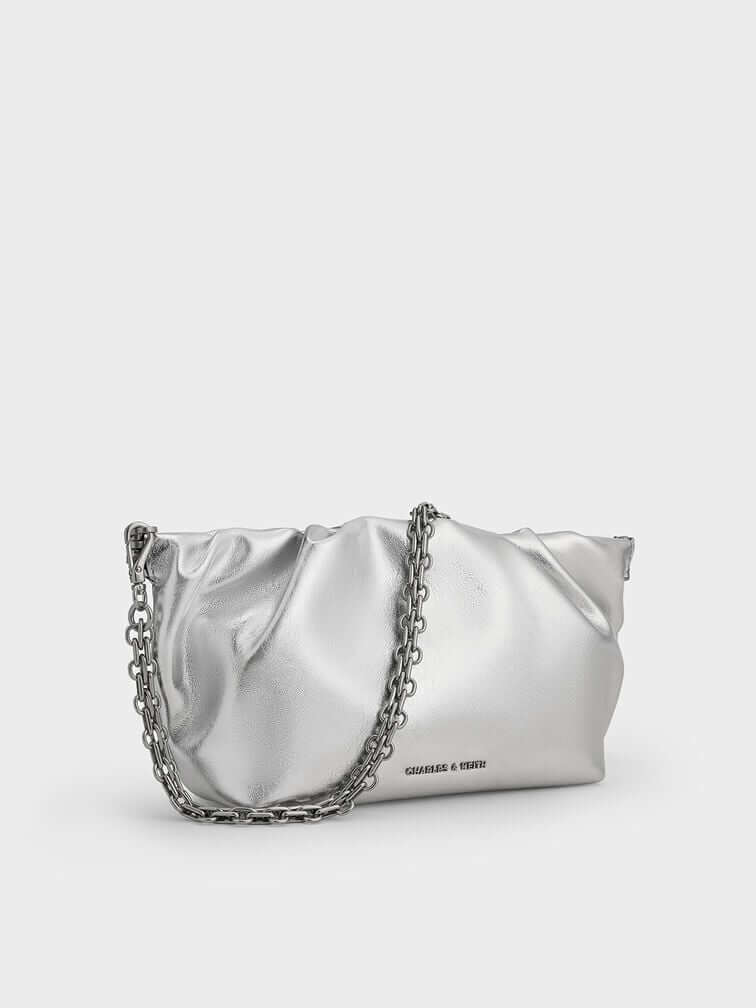 Metallic ruched clutch with chain strap, a striking choice for the holiday and festive season.