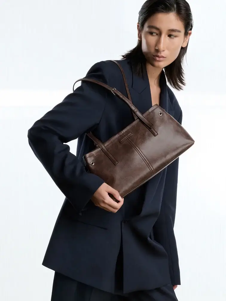 Minimalist East-West bag with a distressed coffee finish.