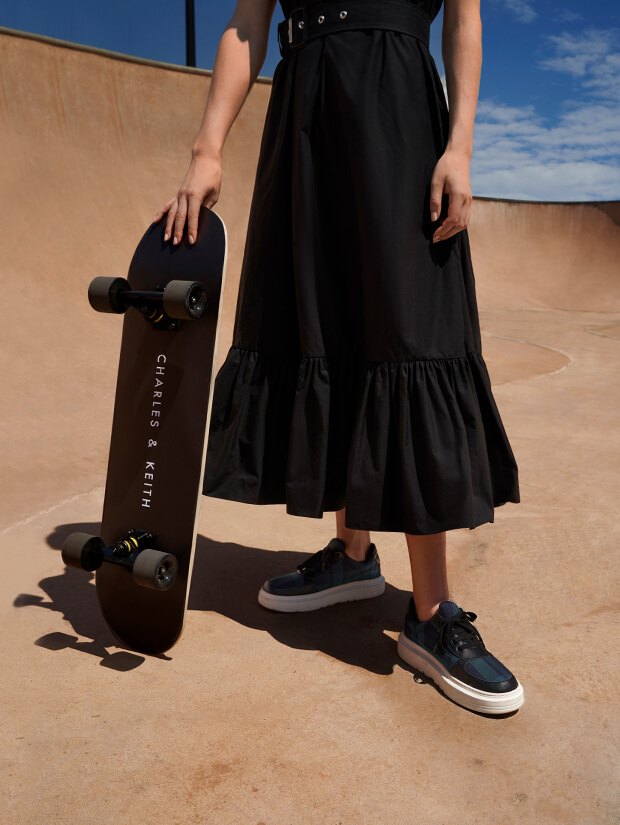 Women’s Stevie tartan print sneakers, featured next to a CHARLES & KEITH branded skateboard