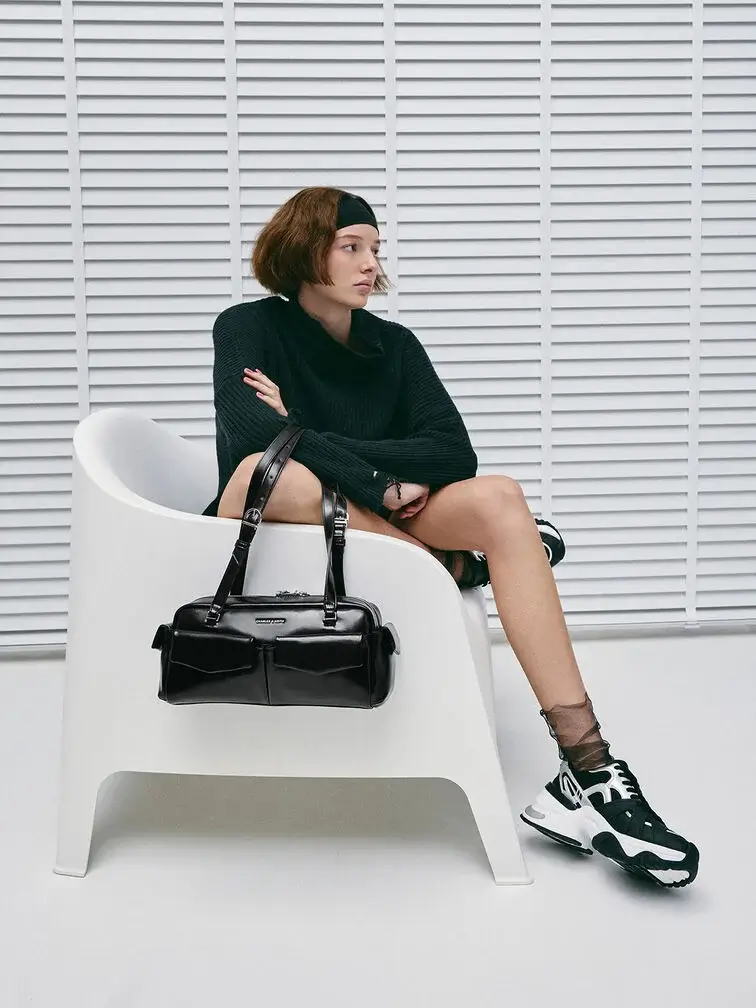 Black East–West bag with multiple pockets makes busy school days easier.