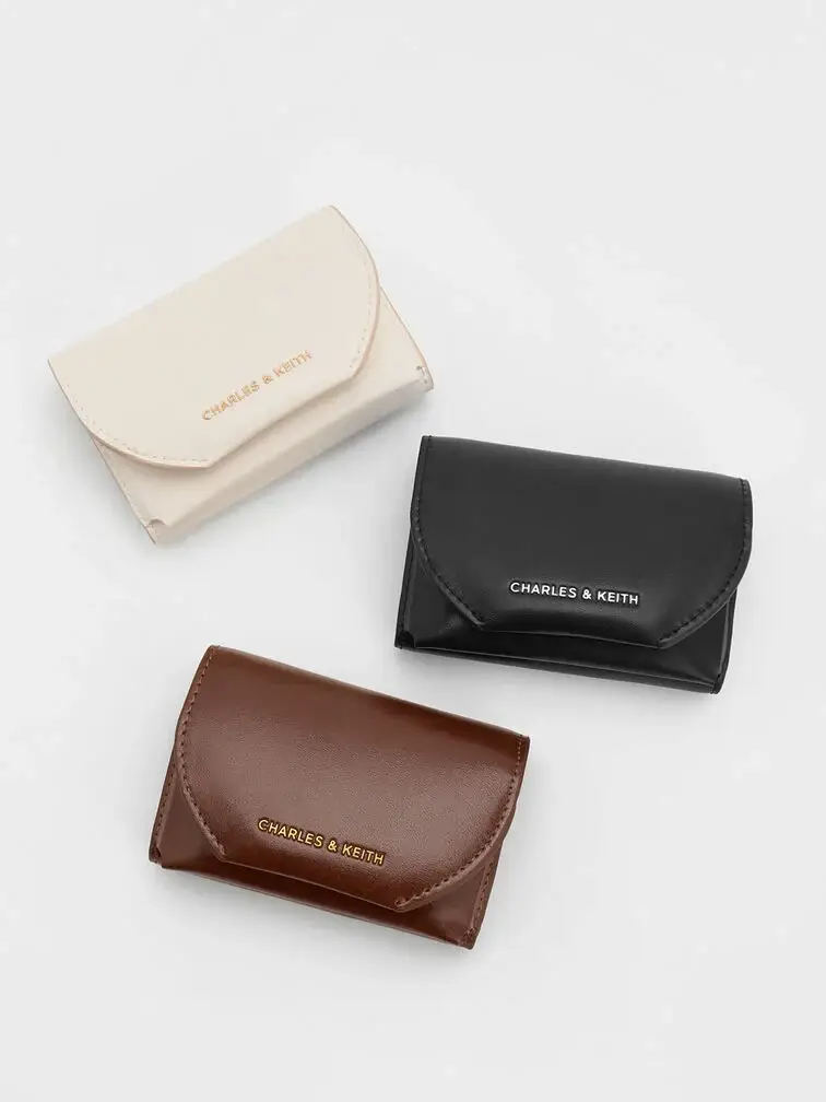 Front flap wallets in neutral colours are thoughtful Secret Santa gifts for daily use.
